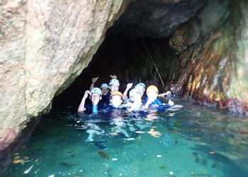 Kid enjoying coasteering in Sant Feliu